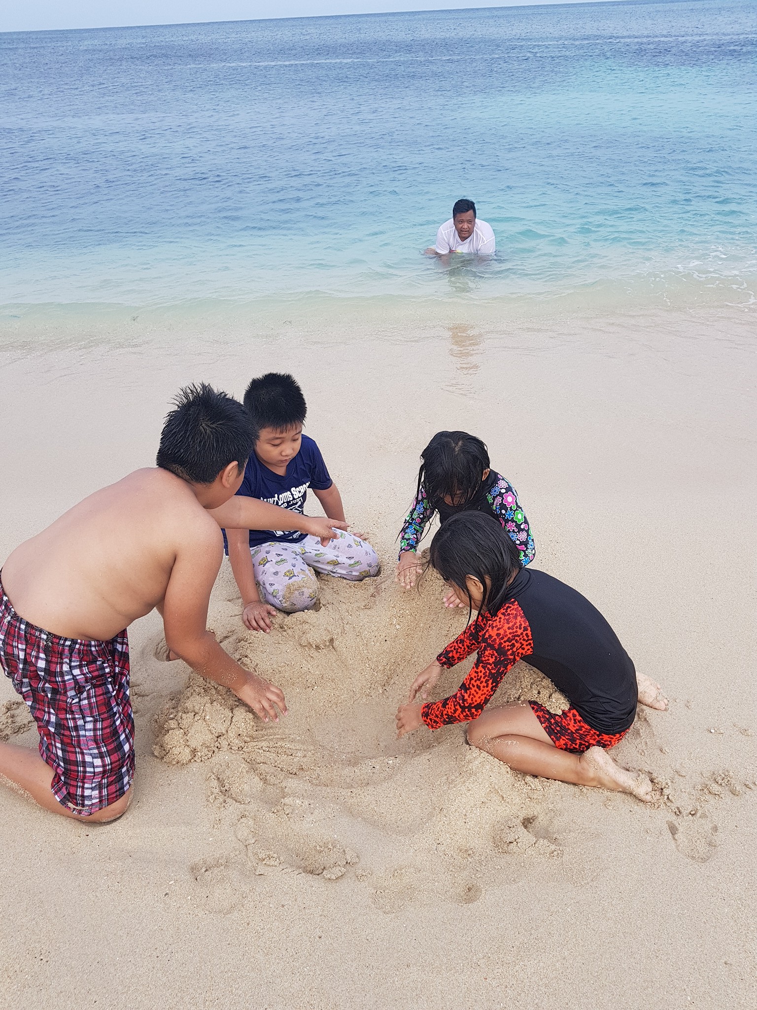 kids playing sand at saud beach