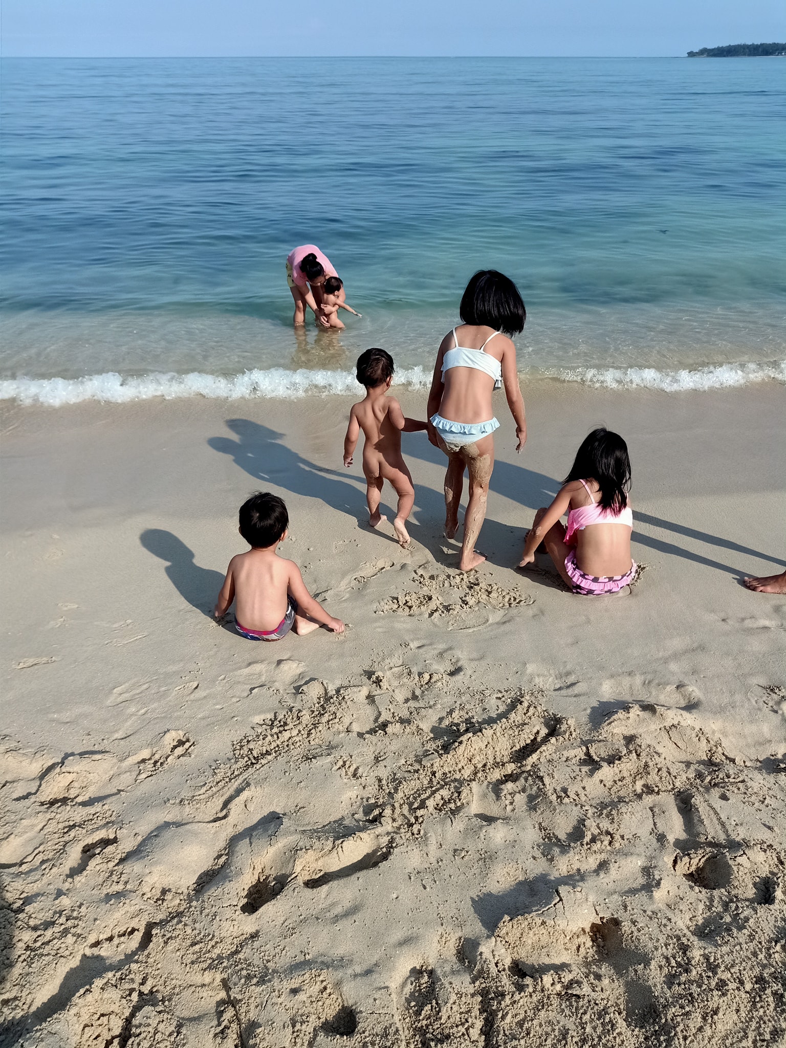 kids with the white sand of pagudpud beach